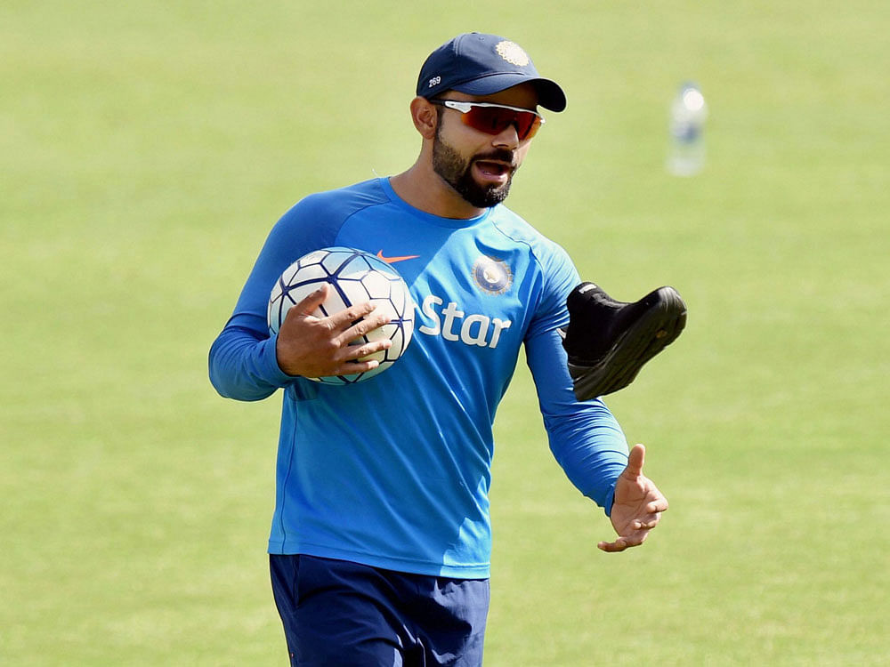 Indian cricket captain Virat Kolhi flings his shoe during a practice session on the eve of the last test match against Australia at the HPCA Stadium in Dharamshala on Friday. PTI Photo