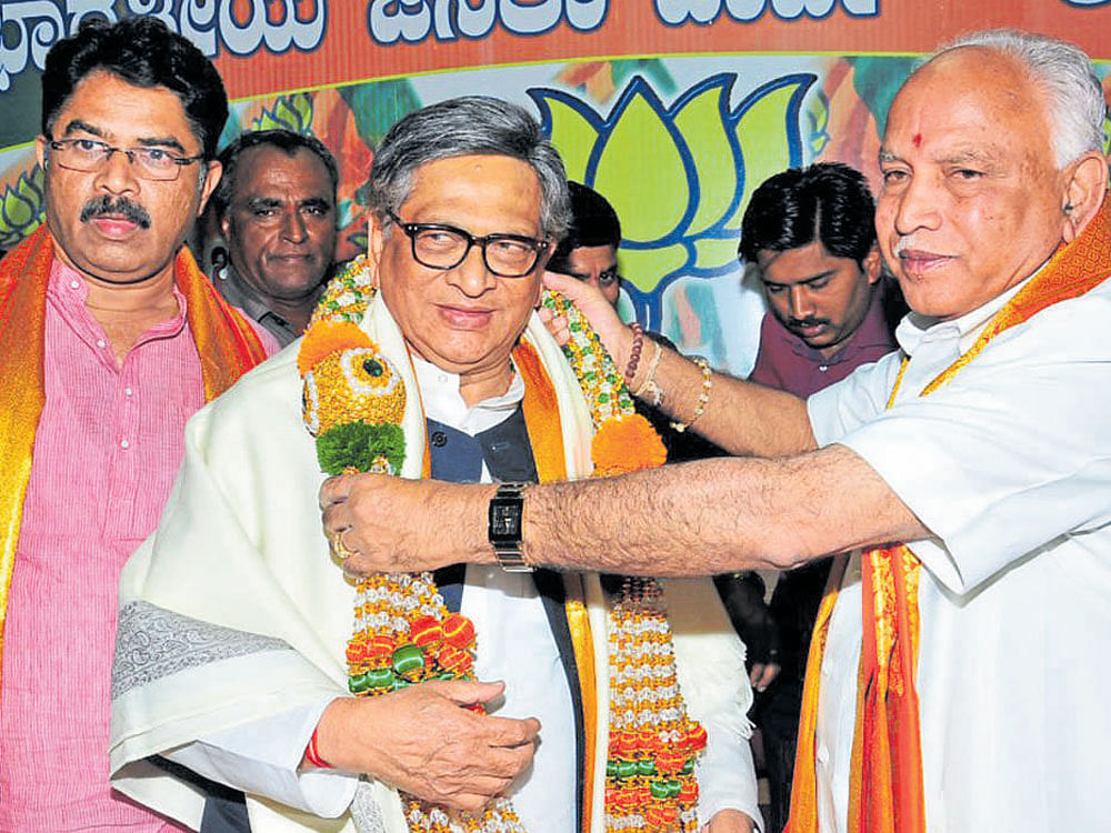 BJP state president B S Yeddyurappa greets former Karnataka chief minister S M Krishna, who joined the BJP, in Bengaluru on Friday. MLA R Ashoka is seen. dh photo