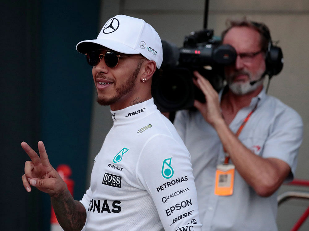 Mercedes driver Lewis Hamilton of Britain reacts after setting pole position in qualifying. Reuters Photo