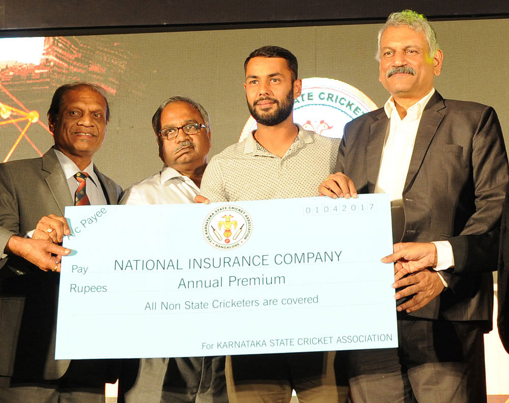 Marking the occasion: India all-rounder Stuart Binny (centre) launches KSCA's insurance scheme for players. DH PHOTOS