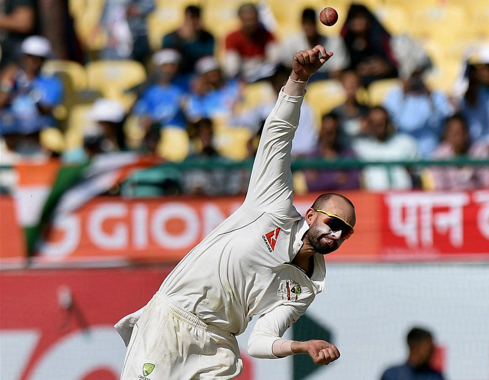 PUTTING THE BRAKES: Australia's Nathan Lyon in action against India during the second day of last test match at HPCA Stadium in Dharamsala on Sunday. PTI Photo
