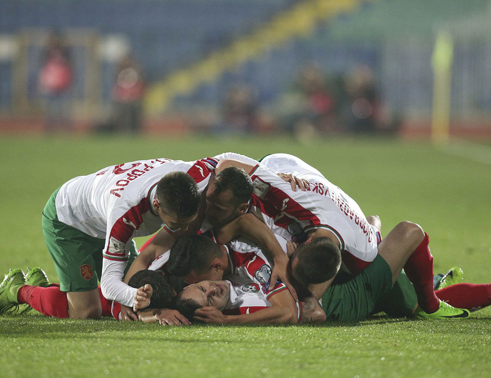 Joyous bunch: Bulgaria's Spas Delev (on the ground) celebrates with team-mates after scoring a goal against the            Netherlands in the Group A World Cup qualifiers in Sofia on Saturday. Bulgaria won 2-0. Reuters