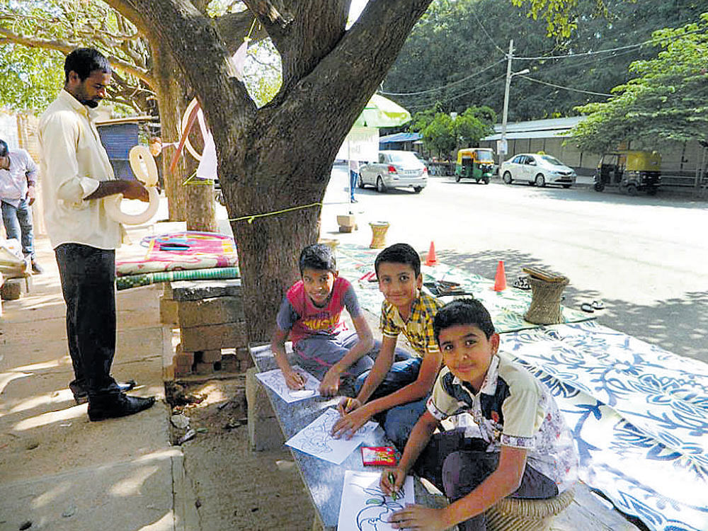 Children take part in a drawing competition at a parking space in HSR Layout recently