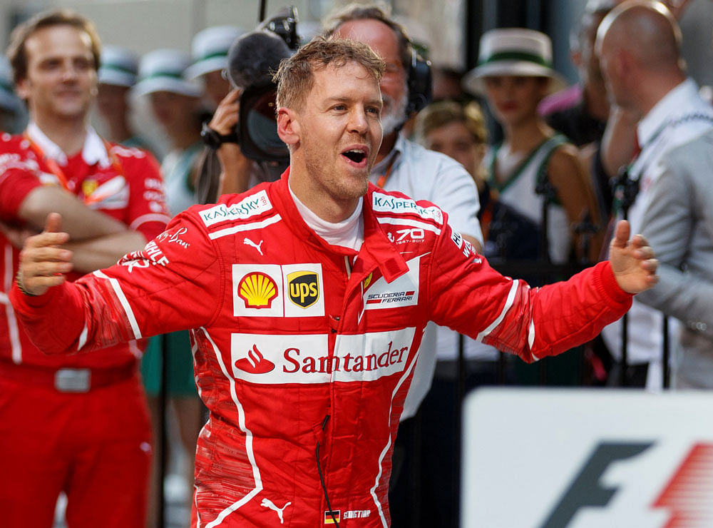 Back on top: Ferrari's Sebastian Vettel exults after winning the season opener at Albert Park in Melbourne on Sunday. REUTERS