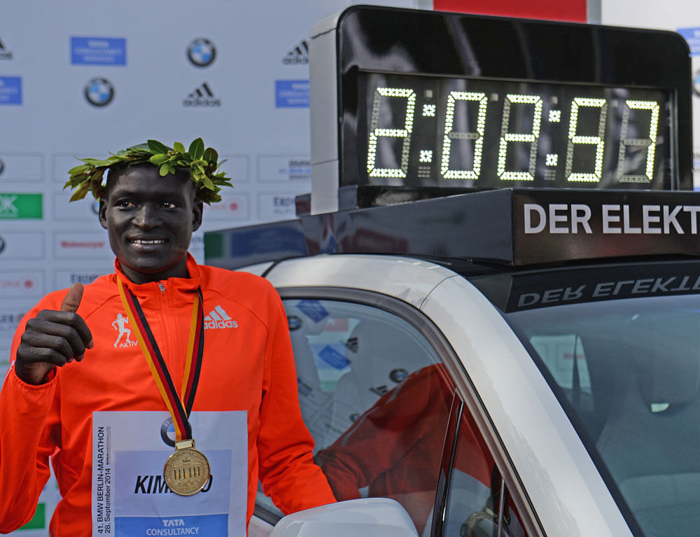 Lightfooted: Dennis Kimetto of Kenya after setting a new world record at the 2014 Berlin Marathon. Lighter shoes make more efficient runners. Had Kimetto's shoes (weighing about 244 gm each) been 100 gm lighter, he might have run the same course one minute faster.