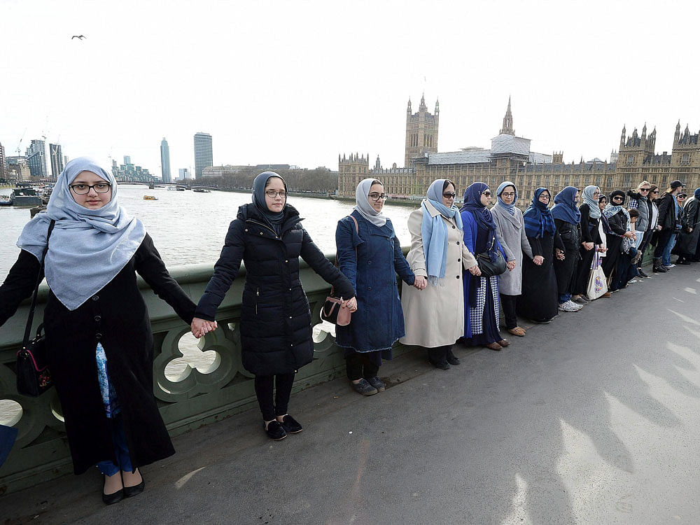 A group of women, some with their daughters, link hands on Westminster bridge in central London in an act of solidarity organised by Women's March London to pay tribute to the victims of the Westminster attack. AP/PTI Photo