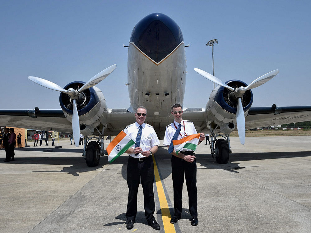 Pilot Francisco Agullo (L) and co-pilot Paul Bazeley of Breitling DC-3 World Tour flight pose for a photo with the 70-year-old aircraft, at the airport in Nagpur on Monday. PTI Photo