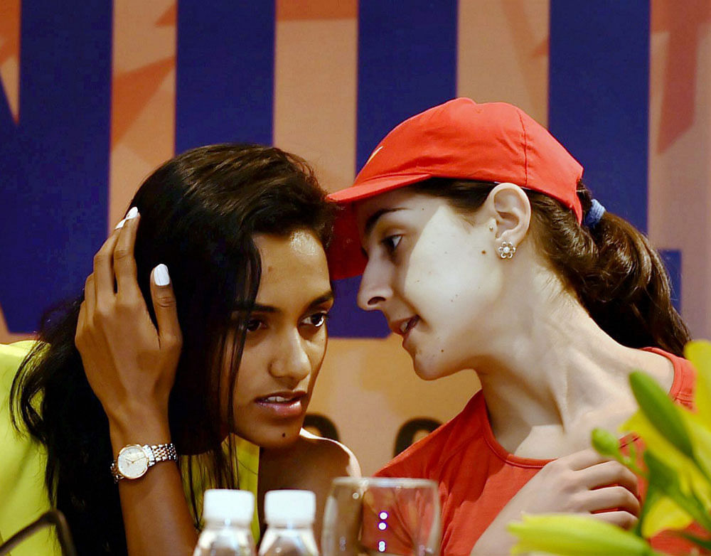 STAR POWER: Spain's Carolina Marin (right) interacts with India's PV Sindhu at a press conference on Monday. PTI