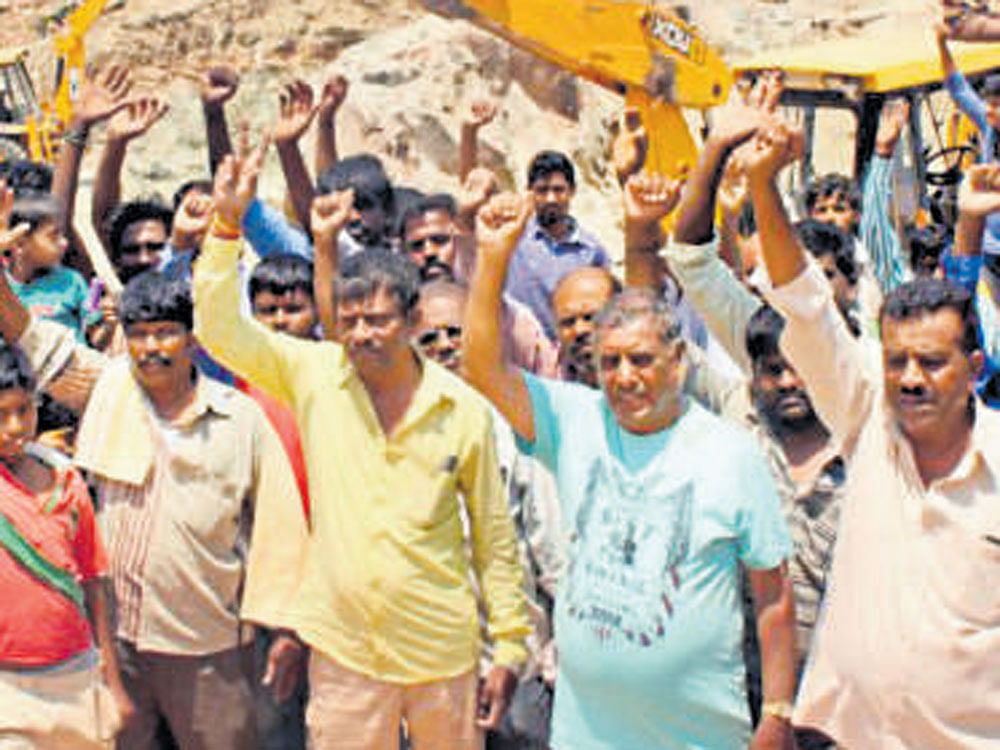 Villagers protest against irrigation officials at Kaggalipura on Kanakapura Road on Monday.