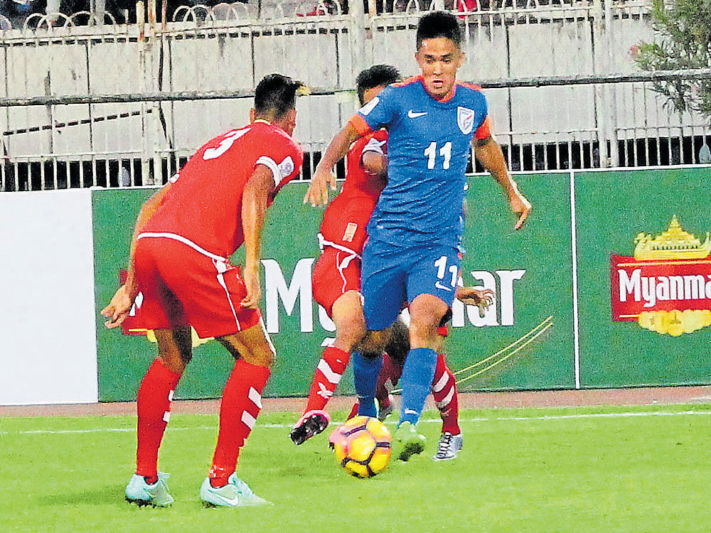 hitman: India's Sunil Chhetri (right) attempts to get past the Myanmar defence during their AFC Asian Cup qualifying tie in Yangon on Tuesday. India won 1-0. Aiff media