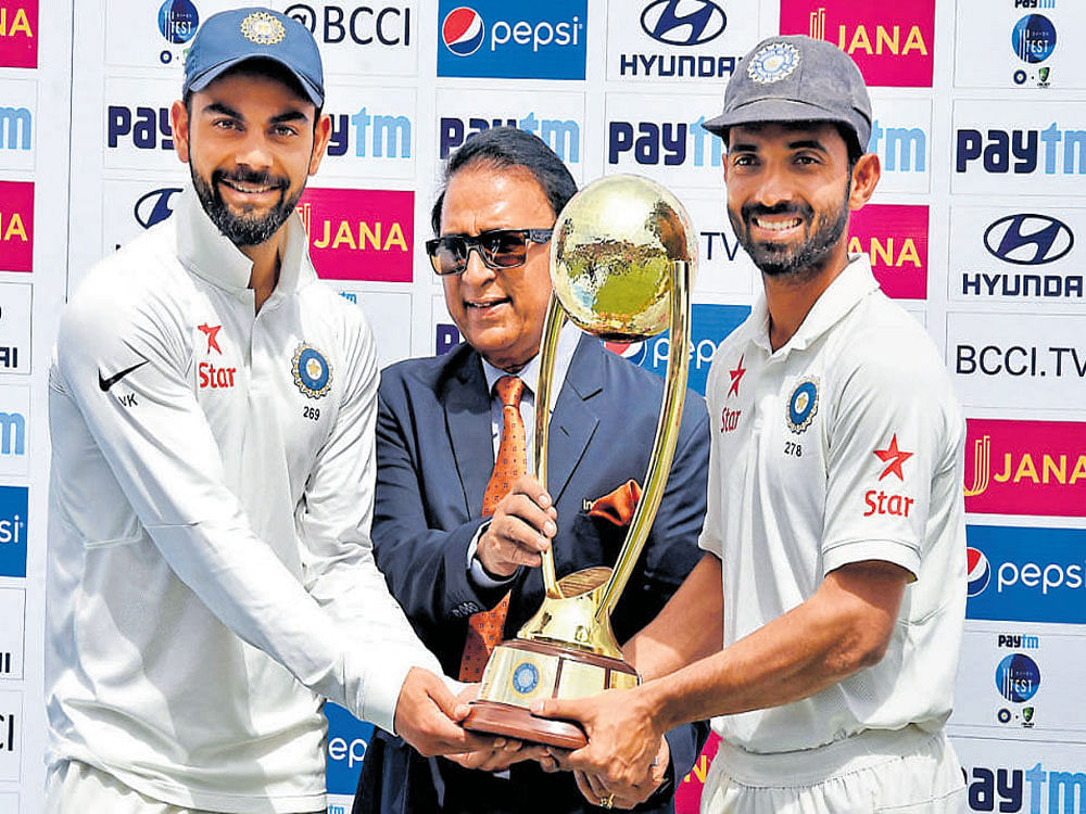 Former India captain Sunil Gavaskar presents the Border-Gavaskar Trophy to Virat Kohli and Ajinkya Rahane after Indiawon the series against Australia on the 4th day of the last Test match at the HPCA Stadium in Dharamsala on Tuesday. India won the series 2-1. PTI