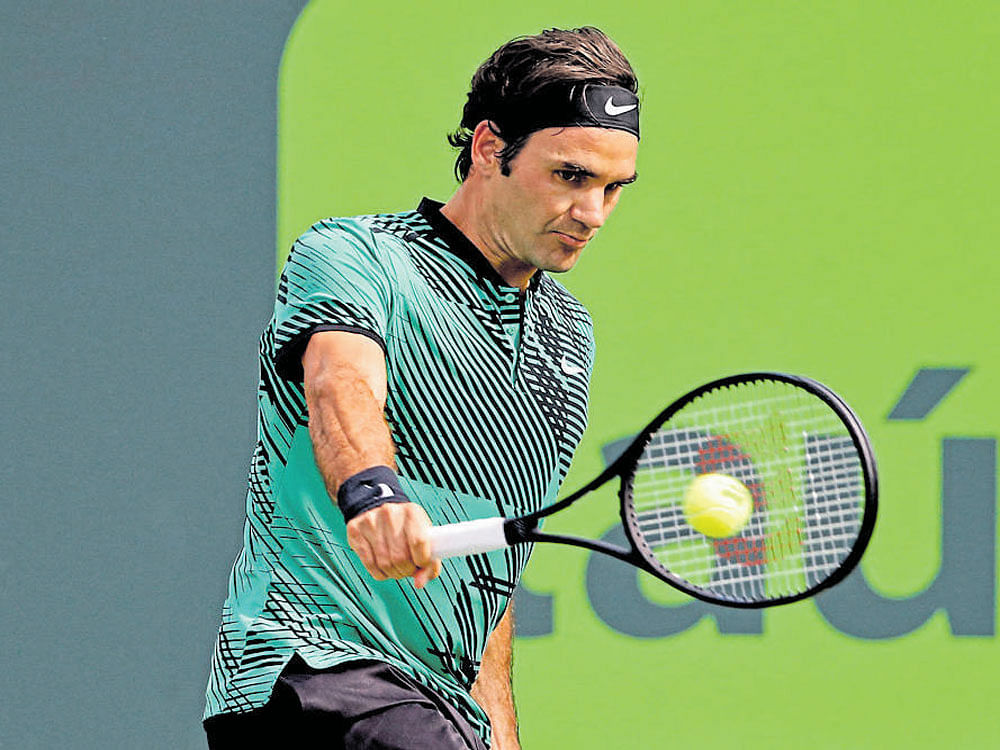 Eyes on the ball Switzerland's Roger Federer essays a backhand during his win over Tomas Berdych. REUTERS