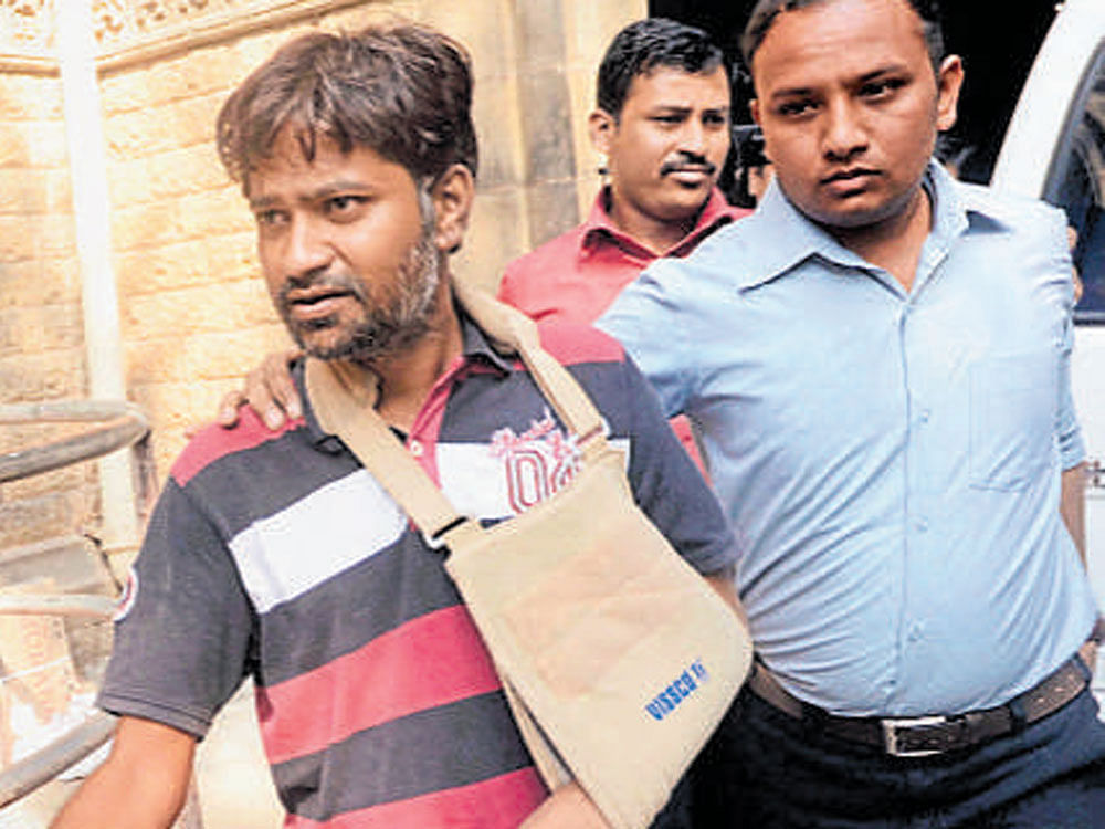 Manish Bhangale being produced in a court in Mumbai on Friday. PTI