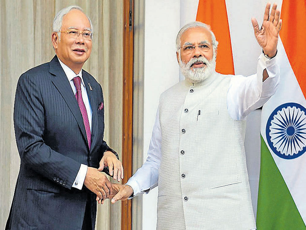 Prime Minister Narendra Modi with  his Malaysian counterpart Najib Razak before their meeting at Hyderabad House in New Delhi on Saturday. PTI