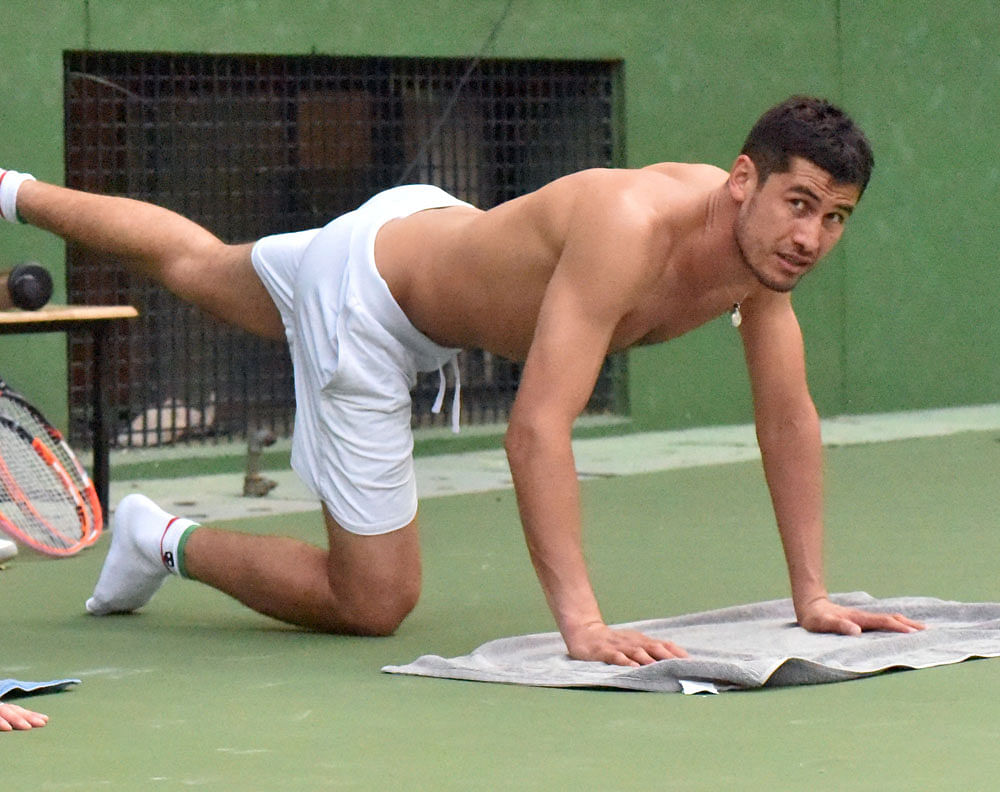 Challenger: Farrukh Dustov of Uzbekistan stretches after  a training session on&#8200;Sunday. DH&#8200;PHOTO/ BK Janardhan
