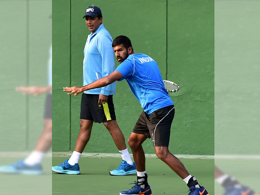 Gearing up: India's Rohan Bopanna during a practice session as non-playing captain Mahesh Bhupathi looks on. DH photo