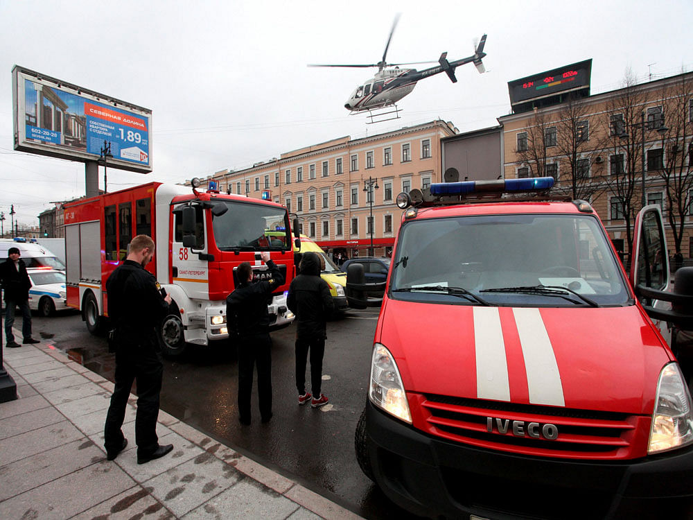 A helicopter flies over the fire trucks after an explosion at Tekhnologichesky Institut subway station in St.Petersburg, Russia. AP/PTI