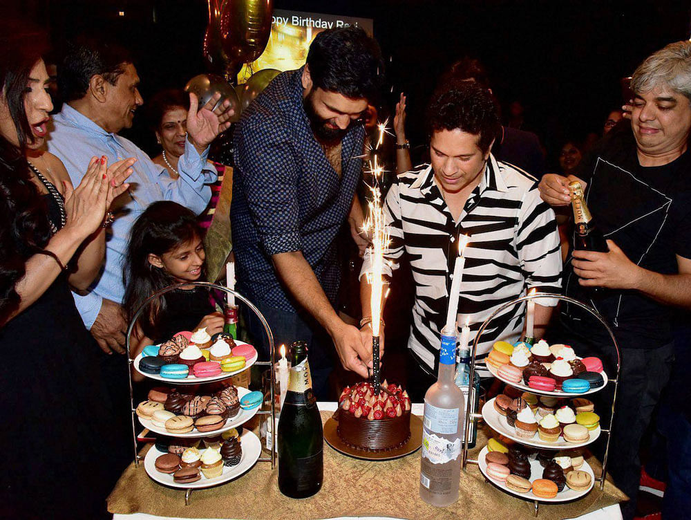 Cricket legend Sachin Tendulkar joins Ravi Bhagchandka (L), the producer of soon to be released film 'Sachin A Billion Dream', in cutting the cake to celebrate the latter's birthday in Mumbai on Monday. The party was also aimed at celebrating the wrapping of the film on the maestro. PTI Photo