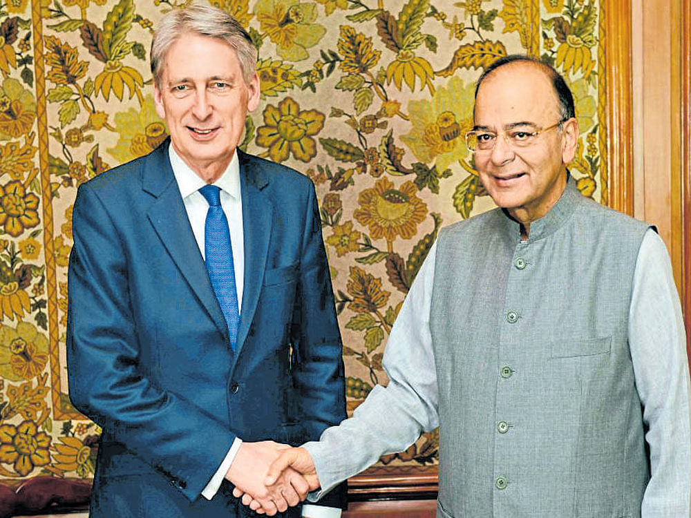 Finance Minister Arun Jaitley (right) greets British finance minister Philip Hammond in New Delhi on Tuesday. AFP