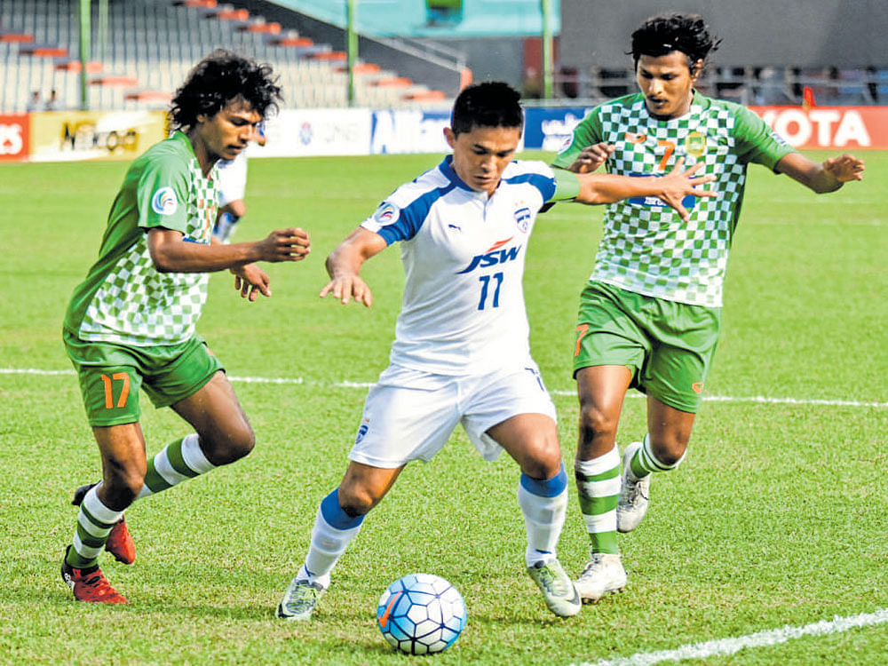 keen tussle Bengaluru FC's Sunil Chhetri (centre) tries to get past Maziya defence during their AFC Cup tie. BFC media