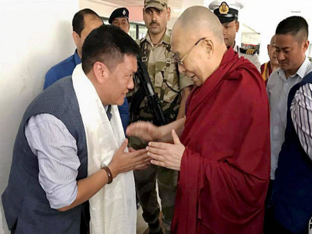 Tibetan spiritual leader The Dalai Lama being welcomed by Arunachal Pradesh Chief Minister Pema Khandu on his arrival at Guwahati airport on Saturday. PTI Photo