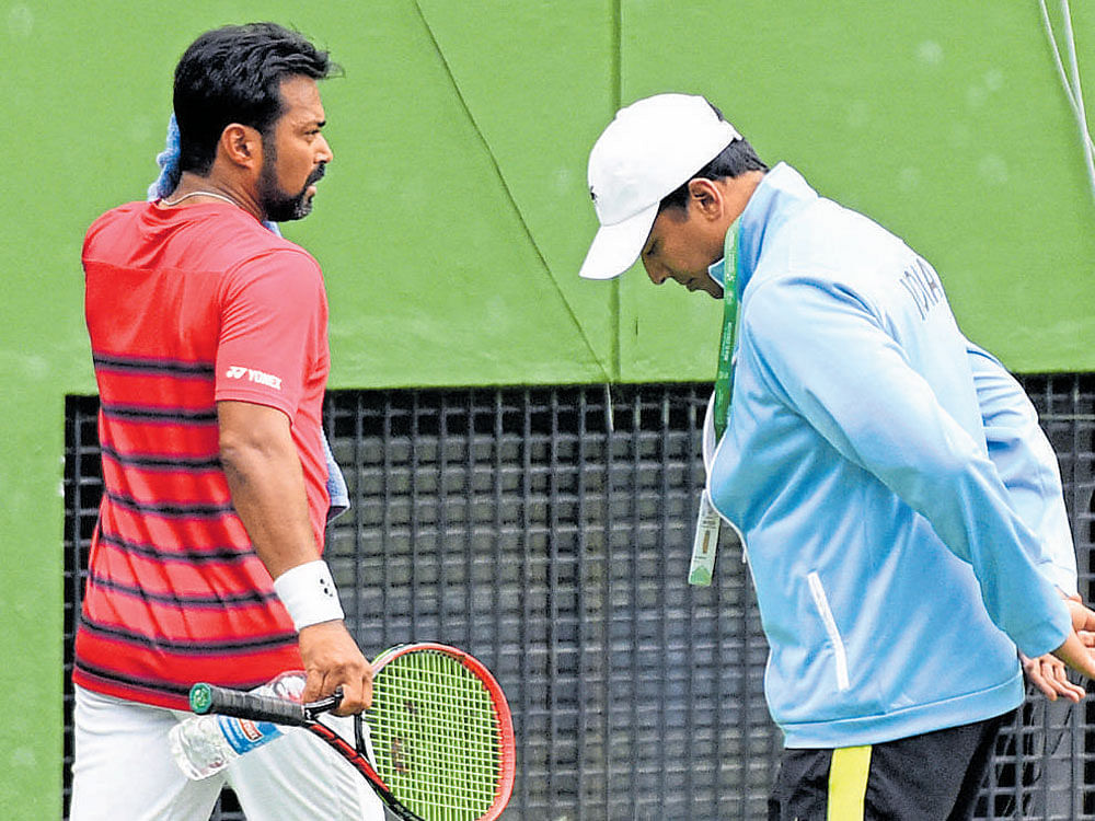 Leander Paes (left) trains at the KSLTAcourts even as India's non-playing captain Mahesh Bhupathi ponders over his plans. DH PHOTO/ SATISH BADIGER