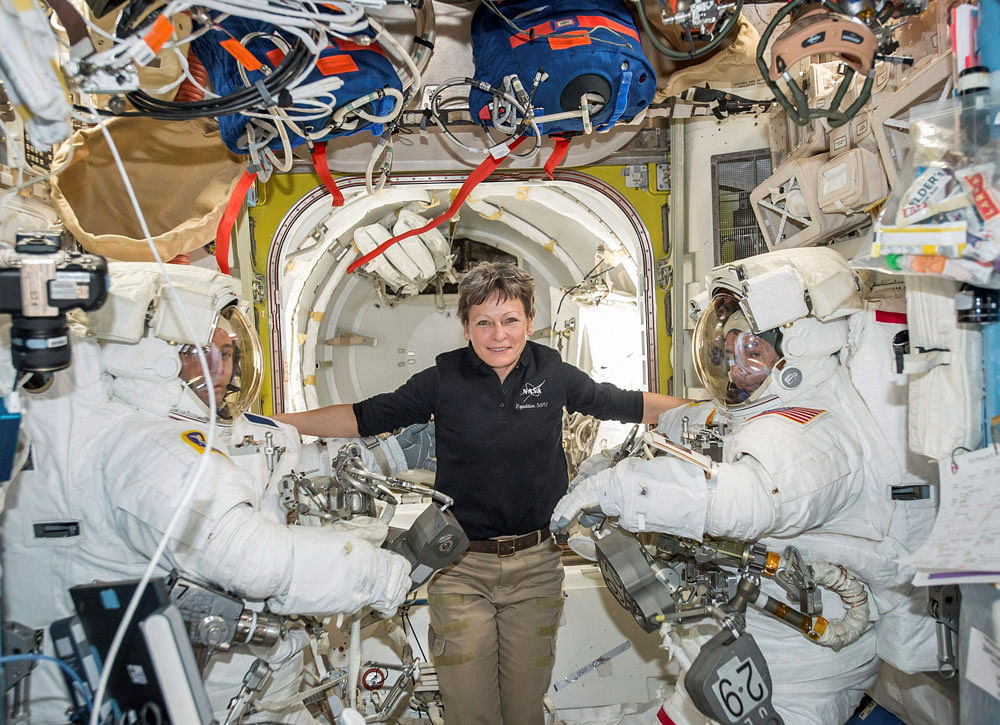 In this Jan. 13, 2017 photo made available by NASA, astronaut Peggy Whitson, center, floats inside the Quest airlock of the International Space Station with Thomas Pesquet, left, and Shane Kimbrough before their spacewalk. On Wednesday, April 5, 2017, NASA announced that Whitson will remain on the ISS until September 2017, adding three months to her original mission.AP/ PTI