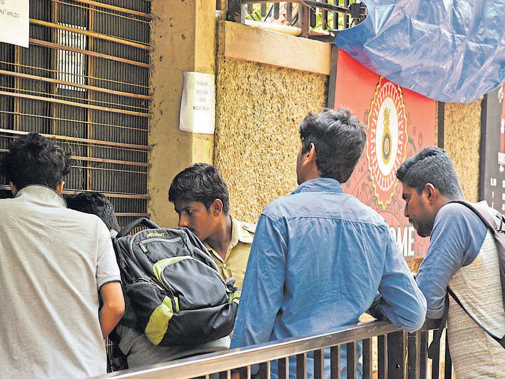 Cricket fans buying tickets at the Chinnaswamy Stadium ahead of the 10th edition of the IPL.  DH PHOTO BY S K DINESH