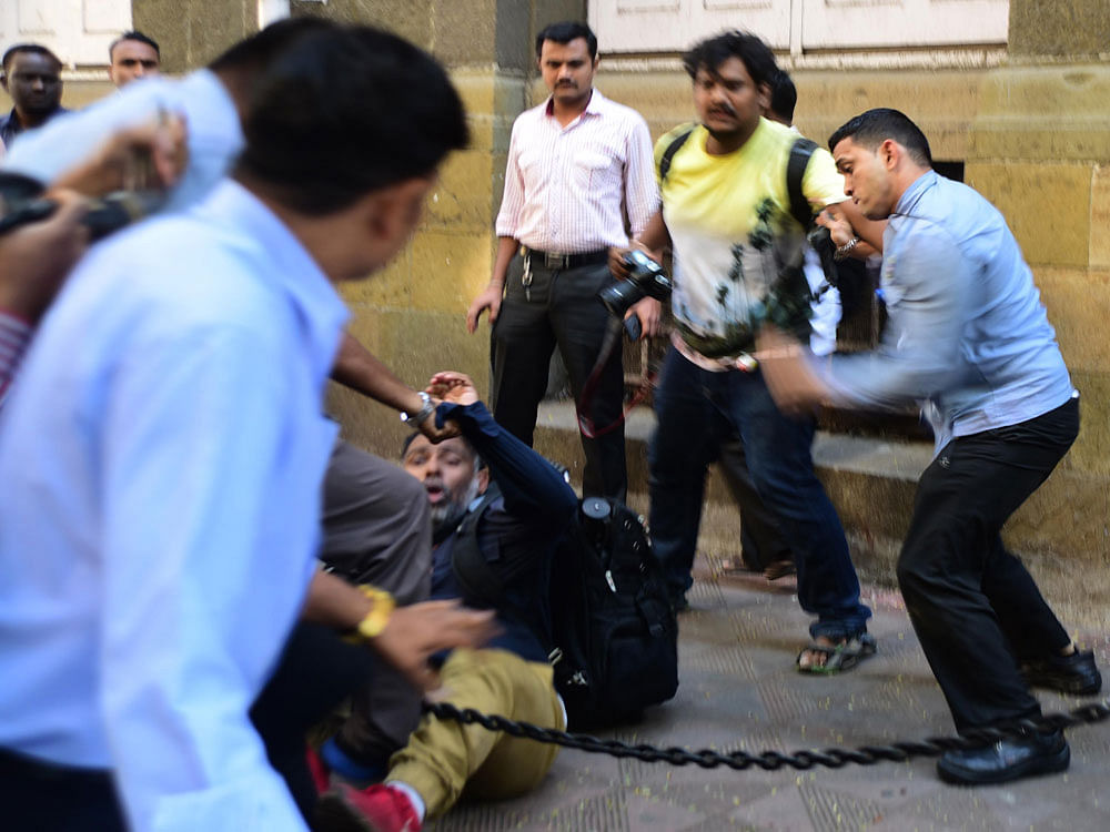 Photo Journalist attacked by locals in Mumbai.  The bill provides for prevention of violence against journalists while carrying out their duties as media persons, and prevention of damage or loss of property of media persons or media houses in the state. DH FIle Photo
