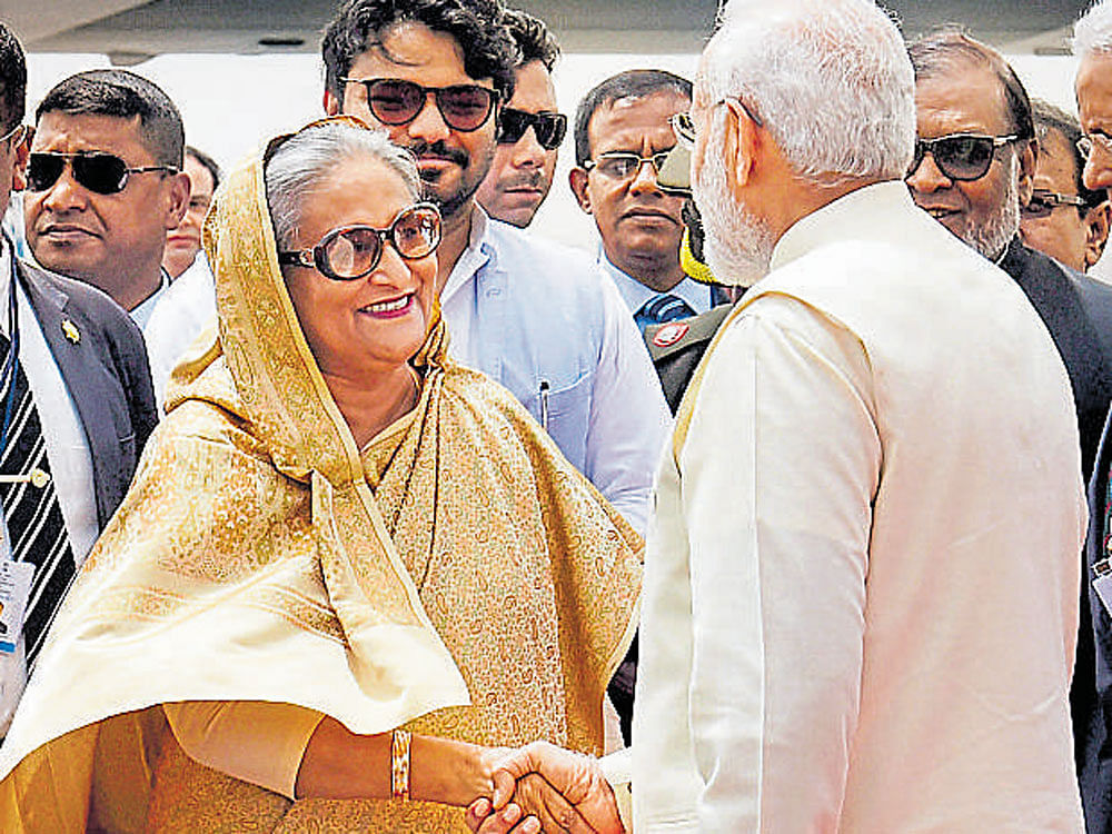 Prime Minister Narendra Modi welcomes Bangladesh Prime Minister Sheikh Hasina as she arrives at the IGI Airport in New Delhi on a four-day visit to India. PTI