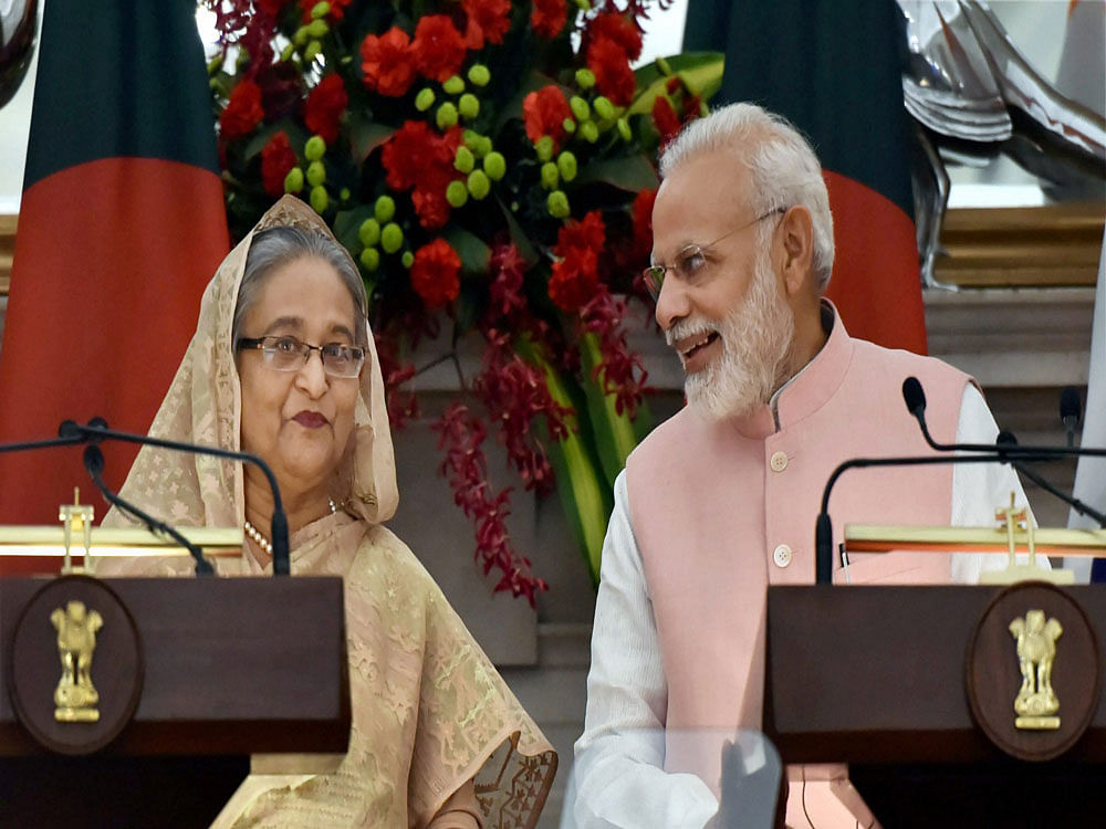 Prime Minister Narendra Modi interacting with his Bangladeshi counterpart Sheikh Hasina during a joint press conference, at Hyderabad house in New Delhi on Saturday. PTI
