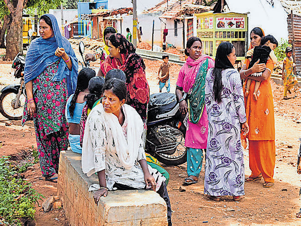 Villagers of Mahadev Nagar in Nanjangud Assembly segment, who had refused to cast their votes were coaxed by local leaders to exercise their franchise on Sunday. DH photo