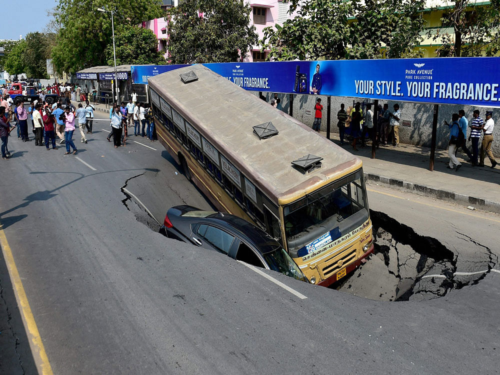 The incident occurred near the site of underground tunnelling for the Metro Rail here. The passengers of the bus evacuated the vehicle after the driver raised an alarm and the car's occupant jumped out after the earth started buckling in. PTI
