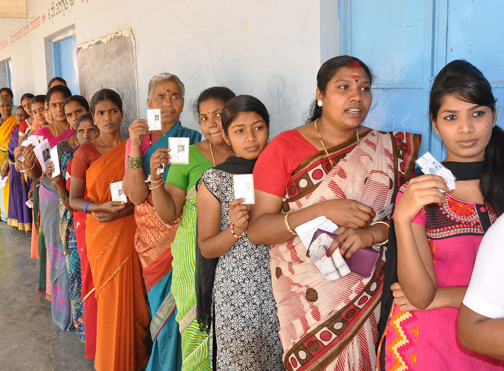 Election scene: Women voters line up to exercise their franchise at a polling booth in Begur village of Gundlupet taluk on Sunday. DH Photo