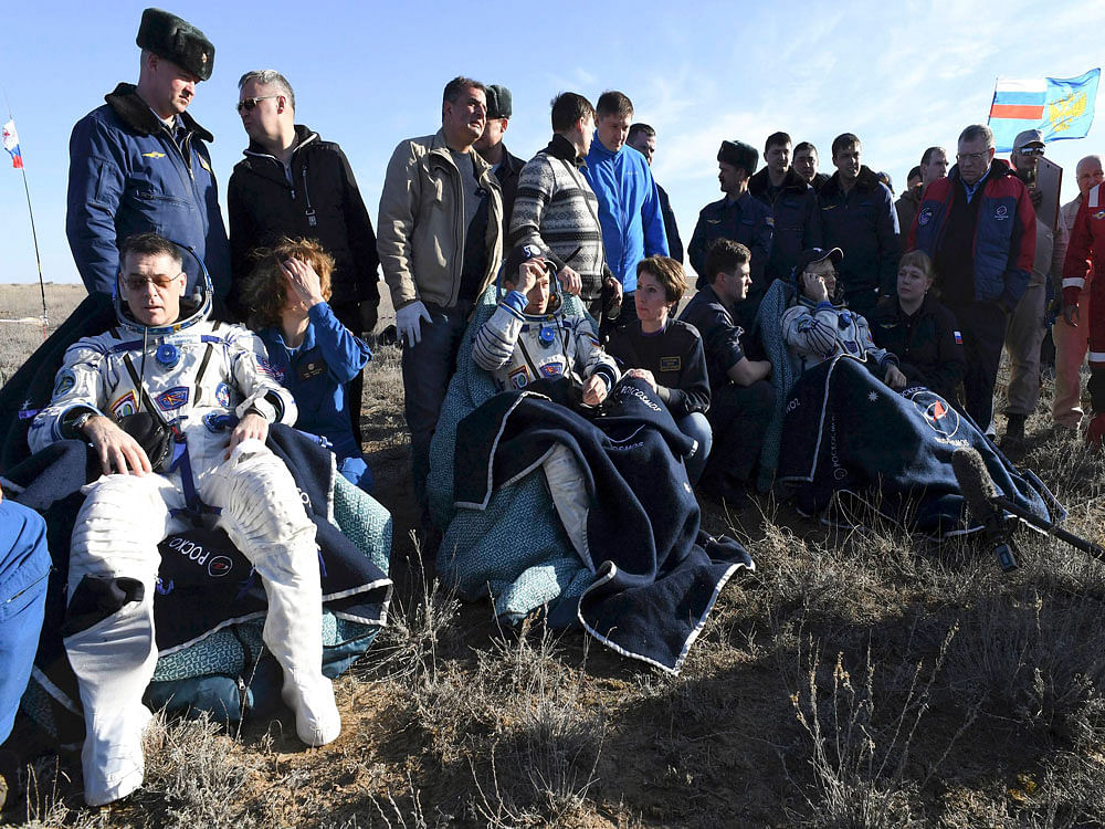 Footage from the landing site showed the trio grinning in the spring sunlight, shaking hands with the recovery team and speaking on mobile telephones. The landing took place in bright conditions at 1120 GMT (5:20 pm local time) southeast of the Kazakh steppe town of Dzhezkazgan. Reuters