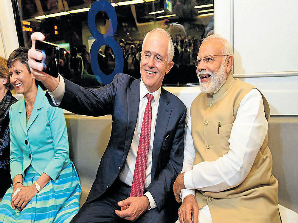 Australian Prime Minister Malcolm Turnbull takes a selfie with Prime Minister Narerndra Modi while travelling in the Metro in New Delhi on Monday. PTI