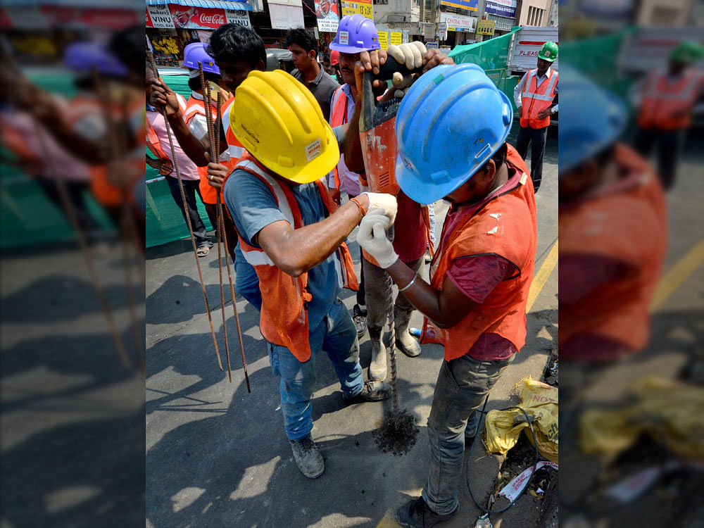 Chennai Metro Rail Limited (CMRL) engineers drilling to inspect if there is a hollow as fear gripped commuters when cracks appeared again at the busy Anna Salai road in Chennai on Tuesday. PTI Photo