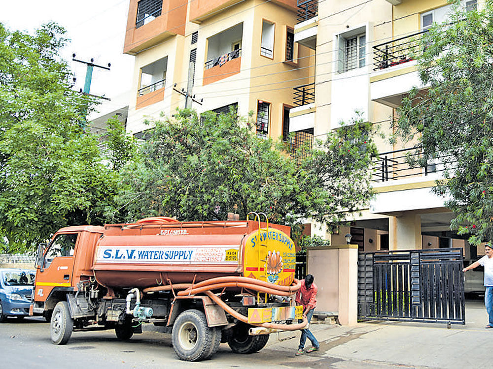 DESPERATE MOVE Many apartments in the city are resorting to water rationing as borewells are drying up. DH PHOTO BY B K JANARDHAN