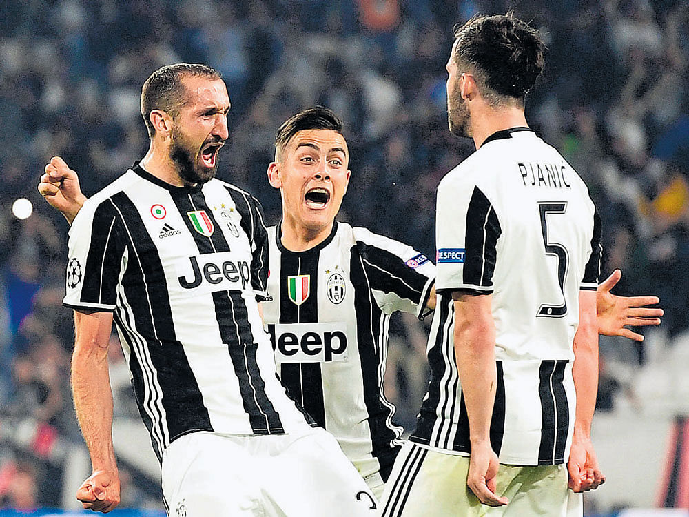 feel the force: Juventus' Giorgio Chiellini (left) celebrates after scoring with Paulo Dybala (centre) and Miralem Pjanic. AFP