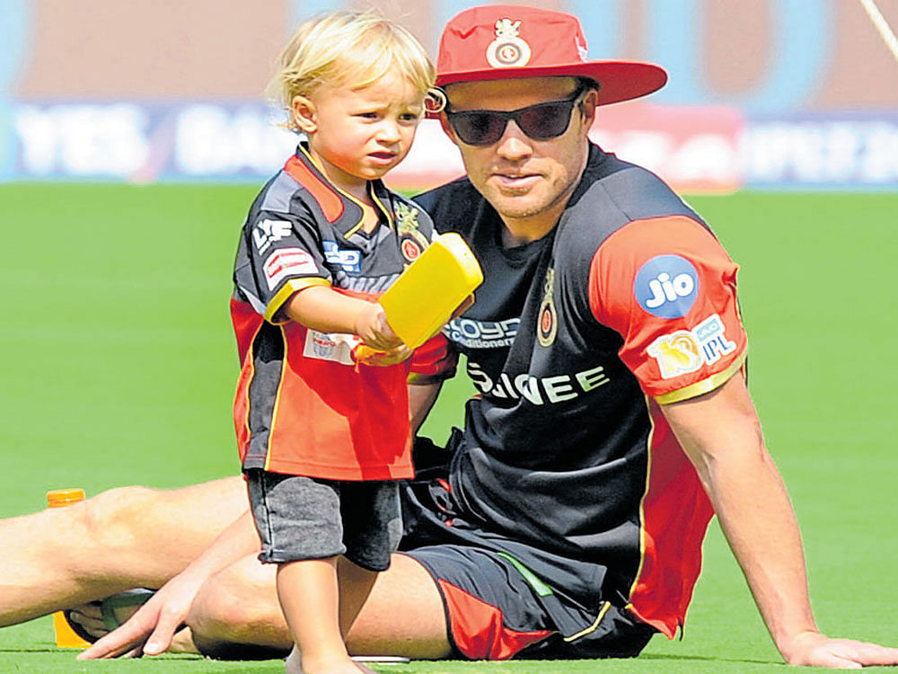 daddy's lessons RCB's AB de Villiers with his son Abraham Benjamin Junior during a practice session on Thursday at the Chinnaswamy Stadium. DH Photo/ Srikanta Sharma R