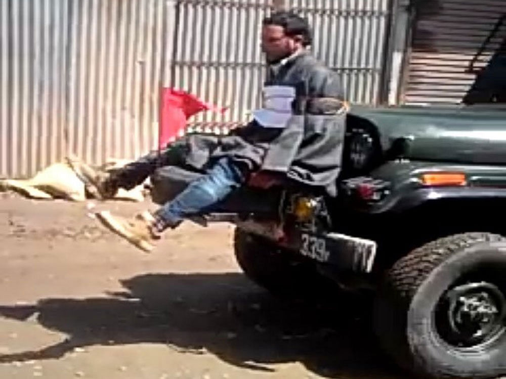 The amateur video, first shared by the spokesperson of Opposition National Conference, shows a young strapped to the front of a jeep being driven as part of a convoy by the Army in Gundipora, Beerwah in central Kashmir's Budgam district. Image courtesy: Twitter