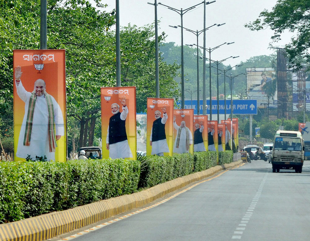 Cut-outs of Prime Minister Narendra Modi and BJP President Amit Shah installed alongside road ahead of the party's national executive body on April 15, in Bhubaneswar on Wednesday. PTI Photo