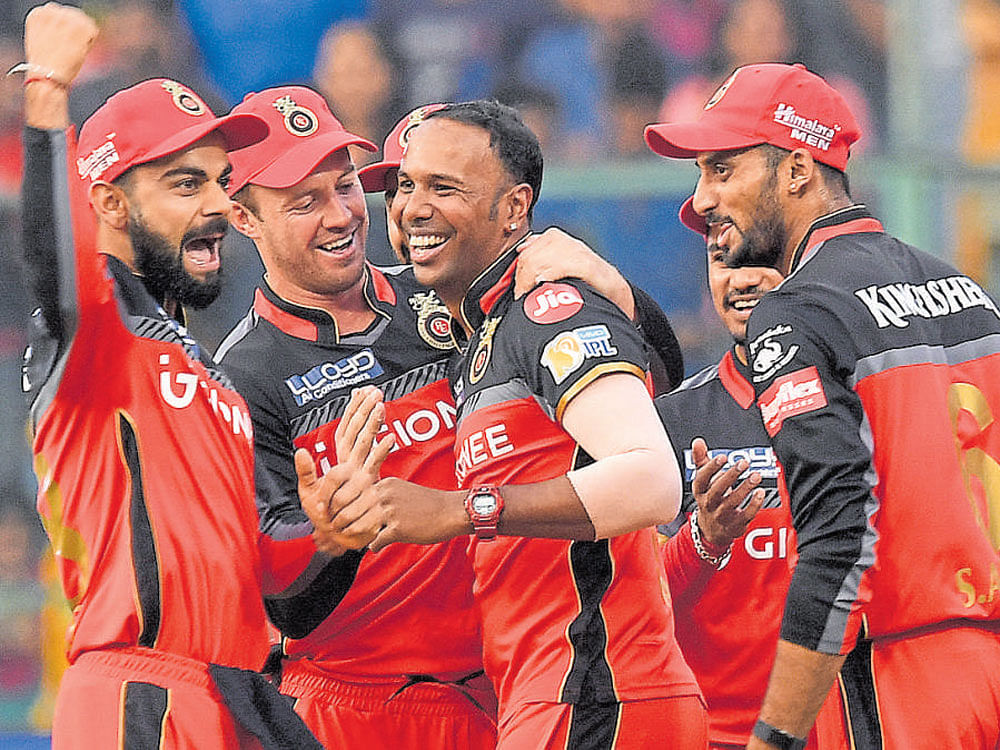 debut to remember RCB's Samuel Badree (centre) celebrates with team-mates after bagging a hat-trick. DH photo