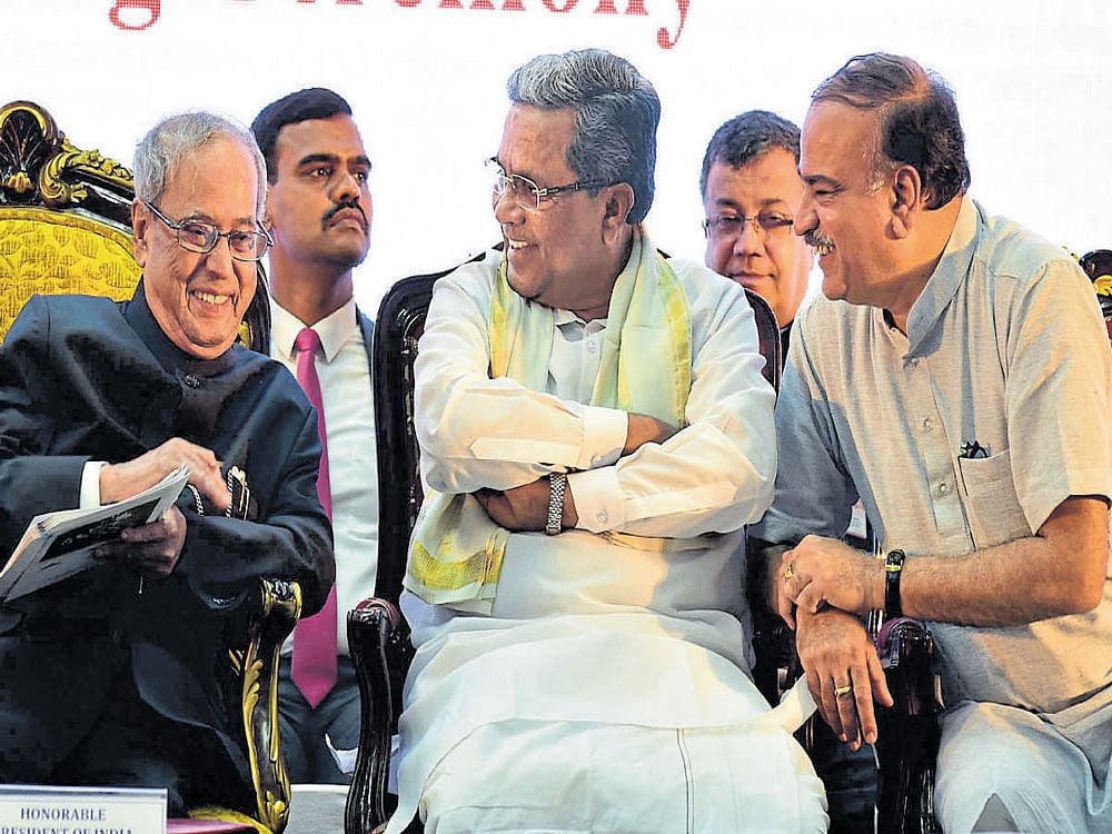 President Pranab Mukherjee shares a lighter moment with Chief Minister Siddaramaiah and Union Minister Ananth Kumar at a function to lay the foundation stone for the Bengaluru  Dr B R Ambedkar School of Economics on Friday. DH photo