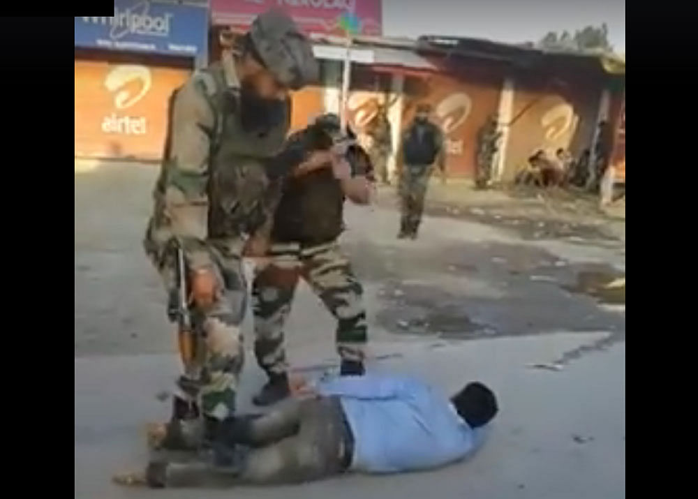 In one of the videos, a student of Pulwama Degree College is purportedly seen pinned to the ground by four army personnel and being thrashed with a cane.