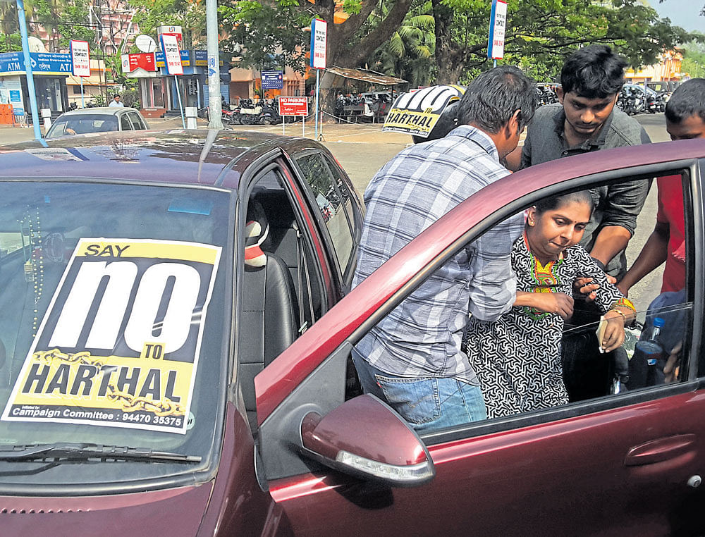 Volunteers of the Say No To Hartal campaign help a woman during a hartal in Kerala.