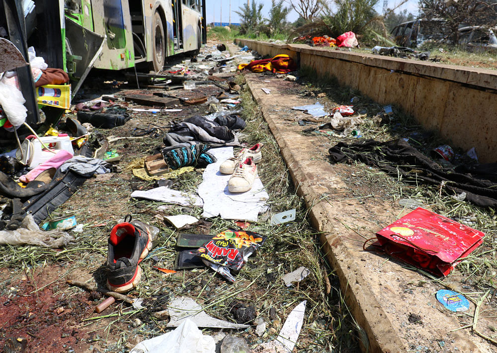 Scattered shoes lie on the ground near damaged buses after an explosion yesterday at insurgent-held al-Rashideen. Reuters