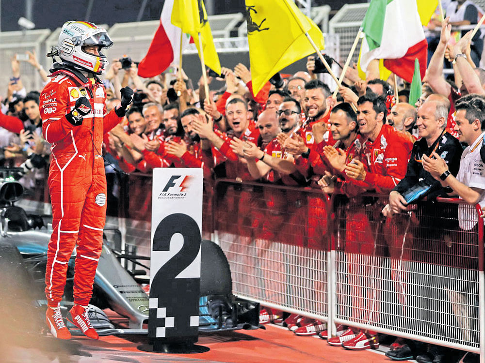 on top again: Ferrari's Sebastian Vettel (left) celebrates his win at the Bahrain GP. AFP