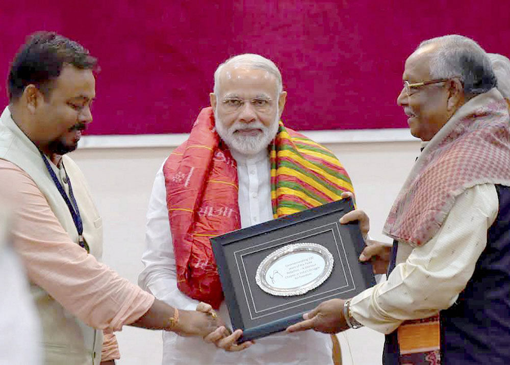 Prime Minister Narendra Modi felicitates the relatives of freedom fighters from Odisha, at a special programme, in Bhubaneswar on Sunday. PTI Photo