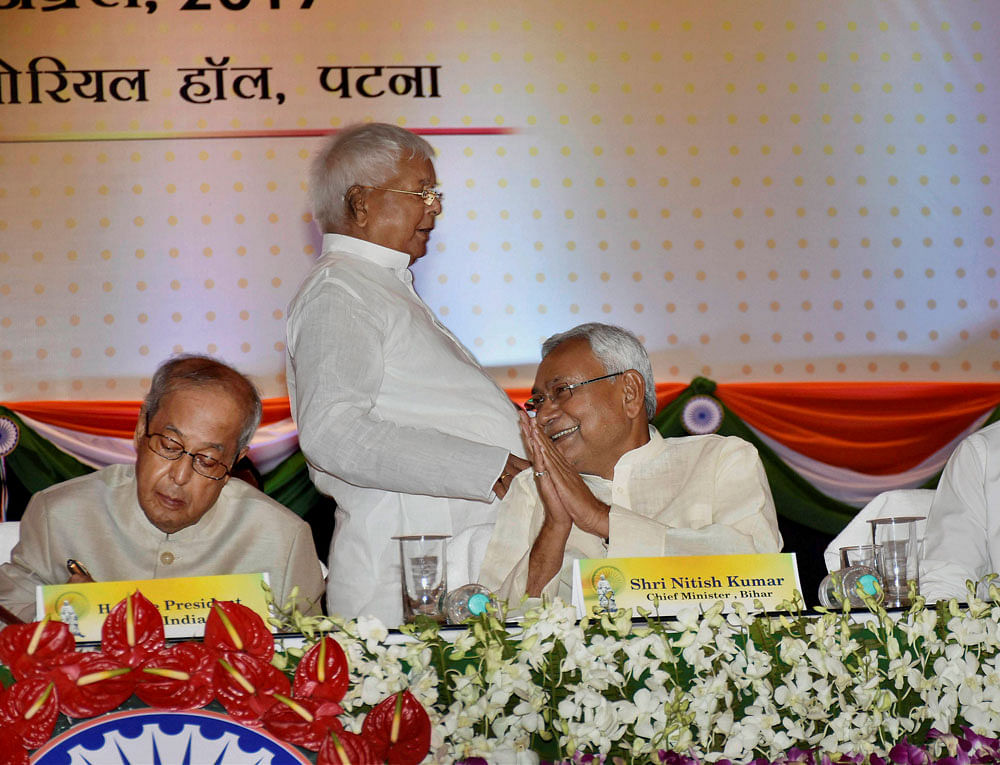 President Pranab Mukherjee with Bihar Chief Minister Nitish Kumar and RJD Chief Lalu Prasad during a felicitation function organised by the Bihar government to mark 100 years of Mahatma Gandhi's Champaran Satyagrah in Patna on Monday. Press Trust of India Photo